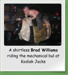 A shirtless Brad Williams riding the mechanical bul at Kodiak Jacks